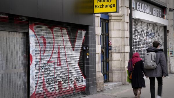 Pedestrians pass a closed down money exchange shop on Oxford Street in London - Sputnik International
