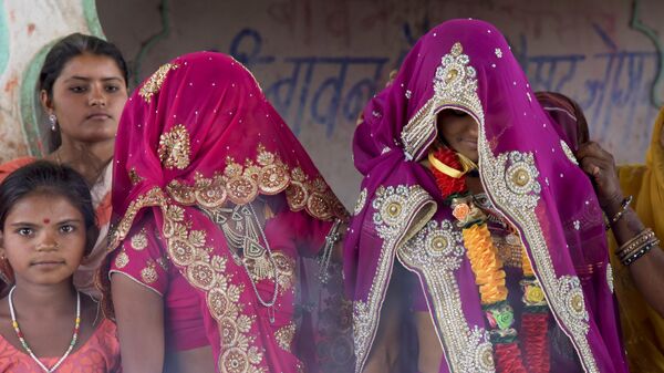 In this April 17, 2017 photo, an underaged bride, right, stands with family members during her marriage at a Hindu temple near Rajgarh, Madhya Pradesh state, India. - Sputnik International