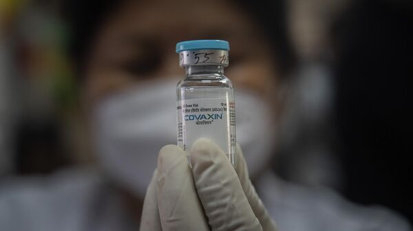 A health worker displays Covaxin COVID-19 vaccine as she prepares to administer the same at a government school in Gauhati, India, Monday, Jan. 3, 2022.  - Sputnik International