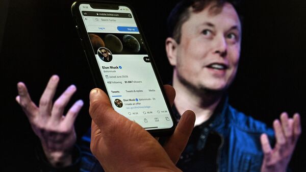 A phone screen displays the Twitter account of Elon Musk with a photo of him in the background, in Washington, DC on April 14, 2022. - Sputnik International