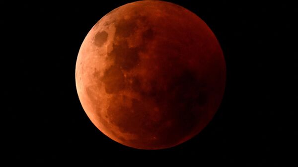 The blood moon is seen during a total lunar eclipse on November 8, 2022. - Sputnik International