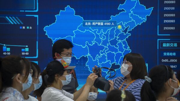 Visitors wearing face masks prepare to put on a virtual reality headset in front of a digital map of China at a booth at the China International Fair for Trade in Services (CIFTIS) in Beijing, Saturday, Sept. 3, 2022. - Sputnik International