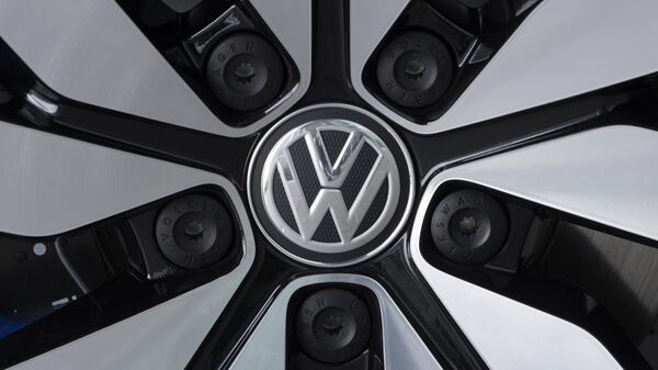 An e-Golf electric car with the VW logo on a rim is pictured in the German car manufacturer Volkswagen Transparent Factory (Glaeserne Manufaktur) in Dresden, eastern Germany - Sputnik International