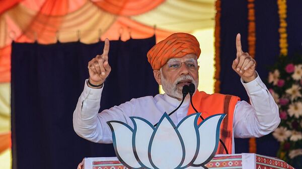 India's prime minister Narendra Modi (C) addresses a gathering during a Bhartiya Janata Party (BJP) rally ahead of Gujarat state elections at Dehgam, some 40 kms from Ahmedabad on November 24, 2022. - Sputnik International