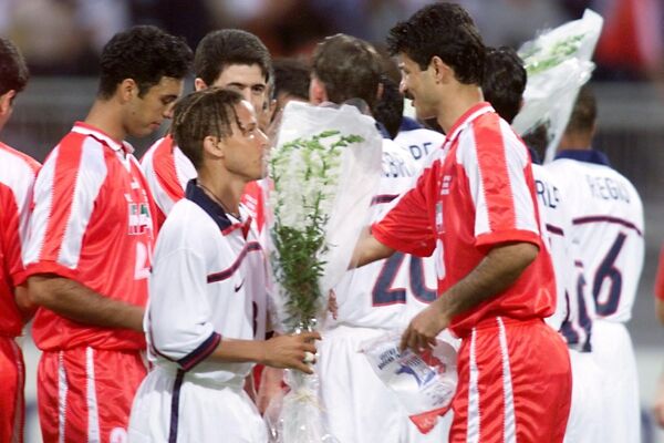 At the pre-match ceremony, Iranian players gave their American opponents white roses as a symbol of peace.Above: US player Cobi Jones (2nd L) offers a bunch of flowers to Iranian Karim Bageri on June 21, 1998, at the Gerland stadium in Lyon, central France, before the World Cup Group F first round match between Iran and the United States.   - Sputnik International