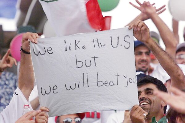 The USA was nominally named the host and the Iranian team were the guests. According to FIFA rules, players of the visiting team approach the home team for a handshake before the game. However, contrary to the rules, the Americans were the first to approach the Iranian players and shake their hands. Above: Iranian supporters display a placard on June 21 at the Gerland stadium in Lyon, central France, before the 1998  World Cup Group F first round match between Iran and the United States.   - Sputnik International