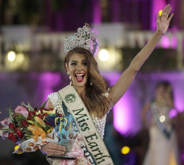Miss Venezuela Alyz Henrich, waves to the crowd shortly after being crowned Miss Earth 2013 in a ceremony on Saturday December 7, 2013, at a housing resort in the suburban Alabang, east of Manila, Philippines. Alyz Henrich was crowned as the new Miss Earth and the second time in history to win this title by a Venezuelan beauty. Her participation has been one of the most successful in the Miss Earth Venezuela, as Henrich was the recipient of numerous awards prior to the final night both from sponsors and the organization of the pageant, having become the first Miss Earth winner to grab the &quot;Best Evening Gown&quot; award as well. - Sputnik International