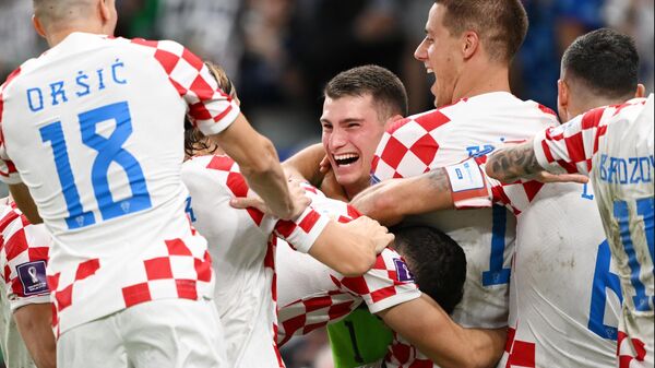 Croatian national team goalkeeper Dominik Livakovic (center) celebrates victory in the 1/8 finals match of the World Cup between Japan and Croatia. - Sputnik International