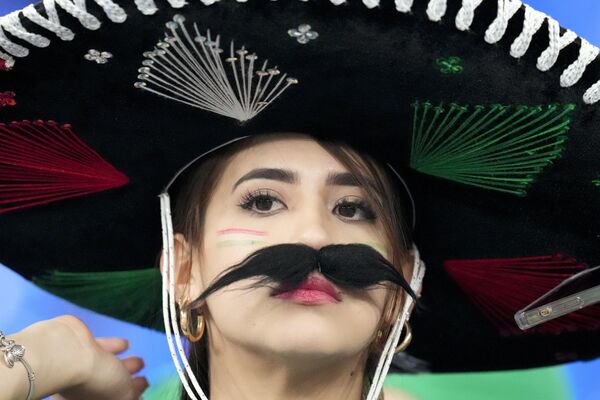 A fan of the team from Mexico watches during warm-ups before the World Cup group C soccer match between Mexico and Poland, at the Stadium 974 in Doha, Qatar, Tuesday, November 22, 2022. - Sputnik International