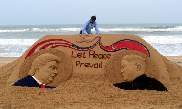 Indian artist Sudarshan Pattnaik, 65, finishes a sand sculpture depicting US President Donald Trump and North Korea&#x27;s leader Kim Jong-un at Puri beach, some 65 km away from Bhubaneswar on June 11, 2018, ahead of the US-North Korea summit. Kim Jong Un and Donald Trump met on June 12 for an unprecedented summit in an attempt to address the last festering legacy of the Cold War, with the US president calling it a &quot;one time shot&quot; at peace. - Sputnik International