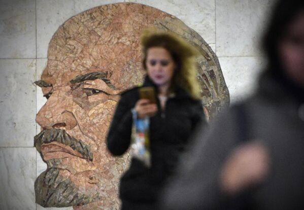 Commuters pass a 1965 mosaic portrait of the Soviet Union founder Vladimir Lenin  by Soviet artist Grigory Opryshko at a metro station in Moscow on October 27, 2017. - Sputnik International
