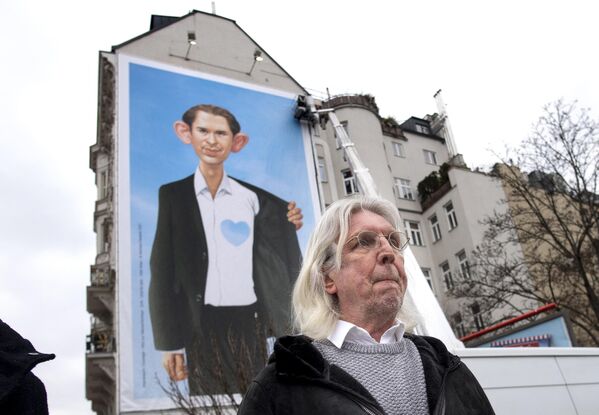 The famous Austrian artist and caricaturist Gerhard Haderer stands in front of a giant poster he created featuring Austrian Chancellor Sebastian Kurz, during a media event titled &quot;Refugees by Initiative Courage&quot; near the Naschmarkt market in Vienna, Austria on March 9, 2021. - Sputnik International