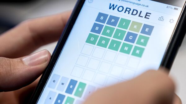 This photo illustration shows a person playing online word game Wordle on a mobile phone in Washington, DC - Sputnik International
