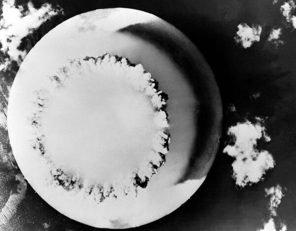A nuclear explosion during the US Operation Crossroads on Ayatollah Bikini in the Pacific Ocean, 1946. Shot from an unmanned aerial vehicle flying over the epicenter of the explosion. View from above the large mushroom cloud generated by the Baker blast, the second in the Operation Crossroads atmospheric nuclear weapons test series at Bikini Atoll. Baker was detonated 90 feet underwater on July 25, 1946. - Sputnik International