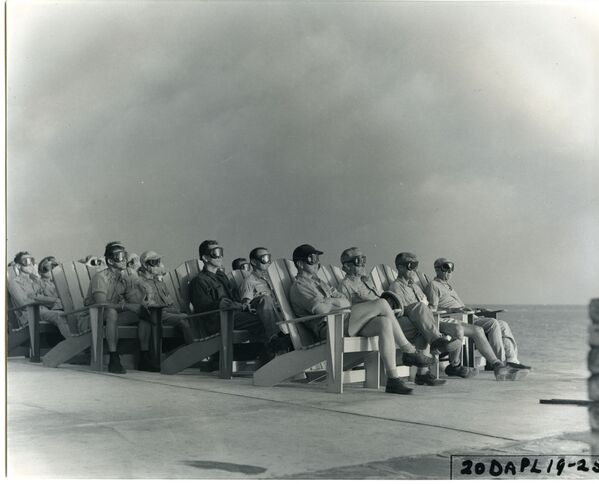 VIP spectators illuminated by the flash of an 81 kiloton charge detonating at Enewetak Atoll. - Sputnik International