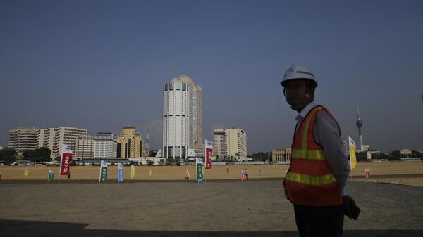A Chinese construction worker stands on land that was reclaimed from the Indian Ocean for the Colombo Port City project on January 2, 2018. The project was initiated as part of China's ambitious Belt and Road initiative in Colombo, Sri Lanka. China says its initiative to build ports and other infrastructure paid for with Chinese loans across Asia and Africa will boost trade.  - Sputnik International