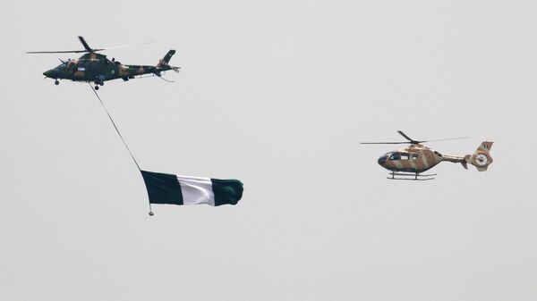 Nigerian Air Force helicopters perfom with the flag of Nigeria during a parade marking the country's 58th anniversary of independence, on October 1, 2018, on Eagle Square in Abuja. - Sputnik International