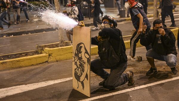 Supporters of former President Pedro Castillo launch firecrackers at riot police during a protest near the Congress in Lima on December 12, 2022 - Sputnik International
