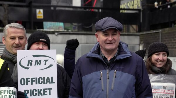 Mick Lynch, general secretary of the Rail, Maritime and Transport union (RMT), joins the members of rail workers during a strike outside Euston station in London - Sputnik International