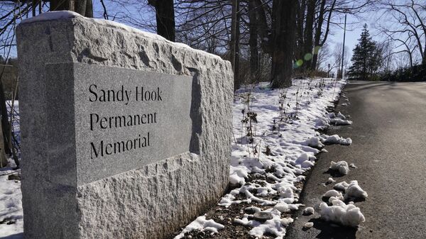 A plaque at the entrance to the The Sandy Hook Permanent Memorial in Newtown, Connecticut, on December 13, 2022 - Sputnik International