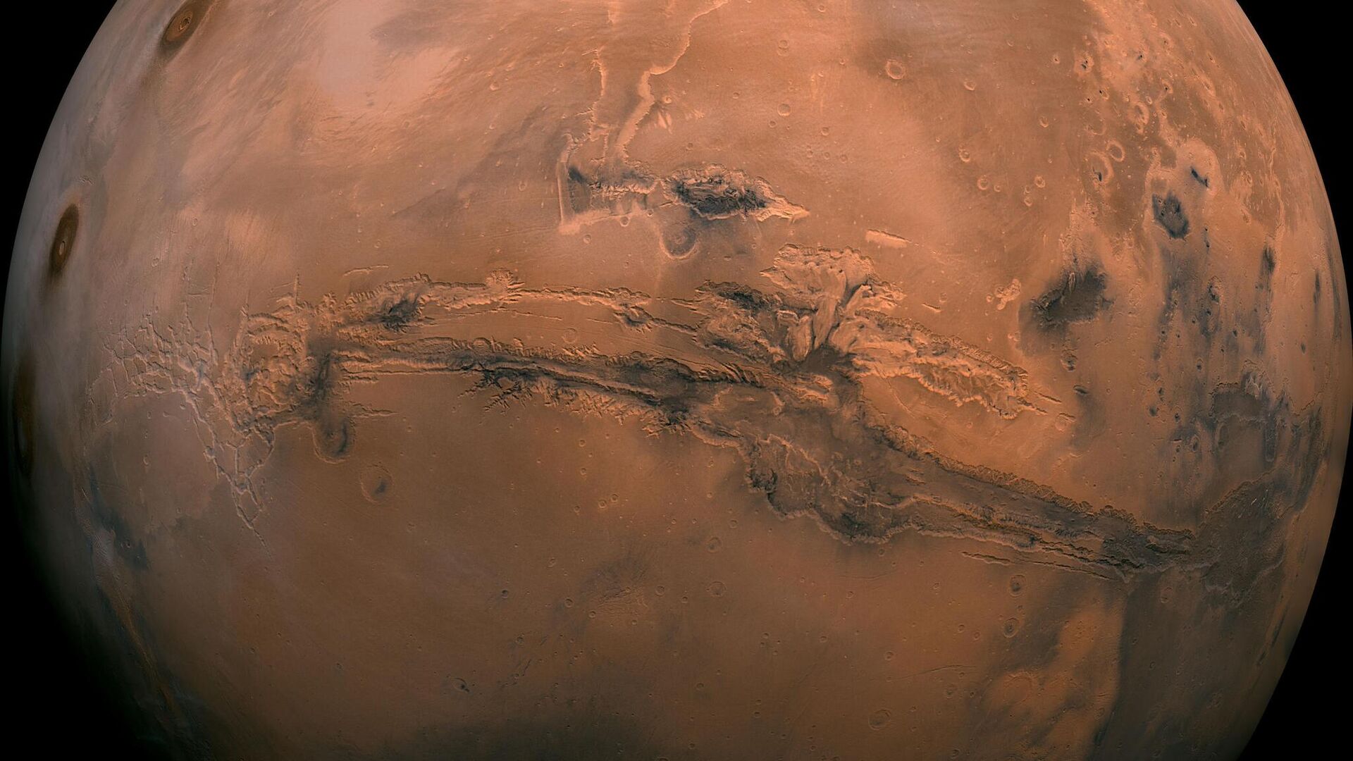 This mosaic of Mars is a compilation of images captured by the Viking Orbiter 1. The center of the scene shows the entire Valles Marineris canyon system, more than 2,000 miles (3,000 kilometers) long, 370 miles (600 kilometers) wide and 5 miles (8 kilometers) deep, extending from Noctis Labyrinthus, the arcuate system of graben to the west, to the chaotic terrain to the east. - Sputnik International, 1920, 10.02.2023