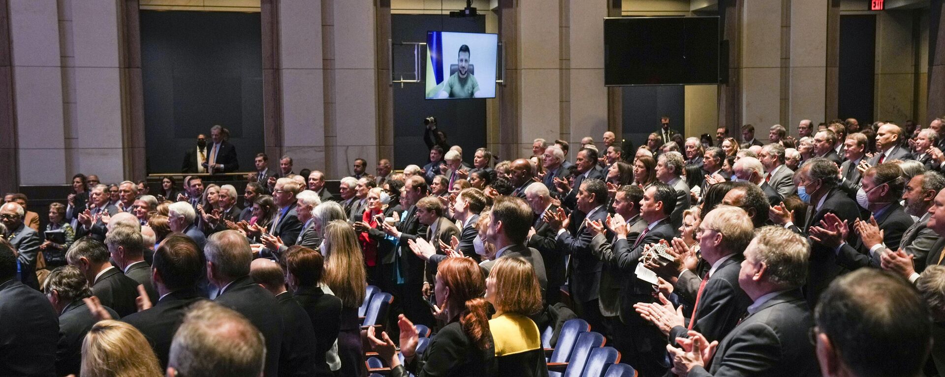 Members of Congress give Ukraine President Volodymyr Zelensky a standing ovation before he speaks in a virtual address to Congress in the U.S. Capitol Visitors Center Congressional Auditorium in Washington, Wednesday, March 16, 2022. - Sputnik International, 1920, 15.04.2025