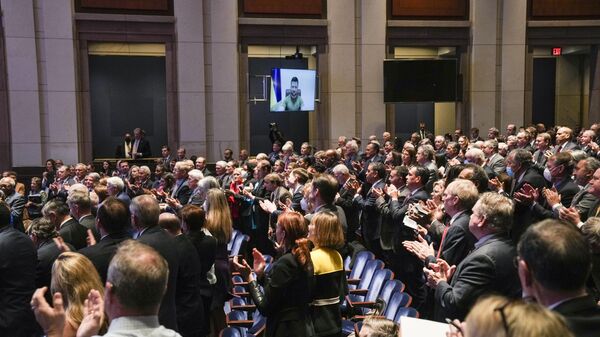 Members of Congress give Ukraine President Volodymyr Zelensky a standing ovation before he speaks in a virtual address to Congress in the U.S. Capitol Visitors Center Congressional Auditorium in Washington, Wednesday, March 16, 2022. - Sputnik International