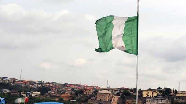 Nigeria's national flag flies above a factory on Ibadan expressway September 8, 2012 in Lagos. - Sputnik International