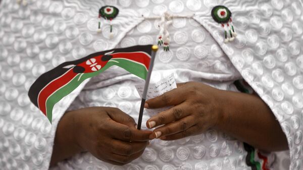 A member of the choir holds a handwritten prayer and a Kenyan flag as she participates in an evangelical pre-election prayer rally for peace, in downtown Nairobi, Kenya Sunday, July 30, 2017. - Sputnik International
