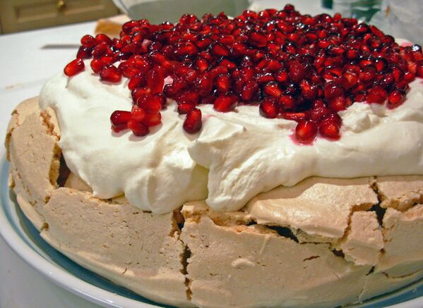 A homemade Pavlova dessert decorated with pomegranate seeds and chantilly cream. A meringue-based dessert, originating in either Australia or New Zealand in the early 20th century. It was named after the Russian ballerina Anna Pavlova. - Sputnik International