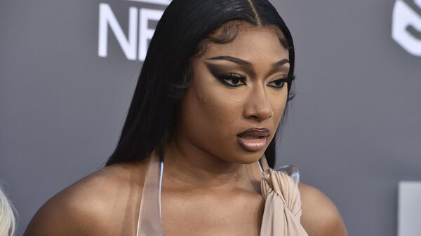FILE - Megan Thee Stallion arrives at the Billboard Music Awards on May 15, 2022, at the MGM Grand Garden Arena in Las Vegas. Megan Thee Stallion is a three-time Grammy winner, hip-hop superstar and entertainer, but none of those things are enough to shield the 27-year-old from widespread misinformation campaigns and social media vitriol since a 2020 shooting involving rapper Tory Lanez.  - Sputnik International