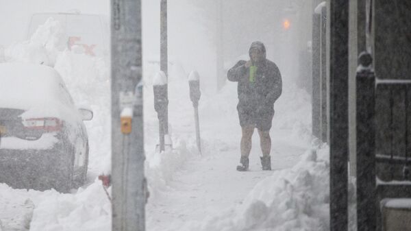 A person walks through downtown in the snow Friday, Nov. 18, 2022, in Buffalo, N.Y.  - Sputnik International
