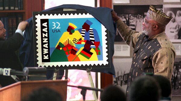 Harold Anderson, left, joins Jose Ferrer, right, chairman of the Kwanzaa Holiday Foundation, to unveil the new Kwanzaa postage stamp at the Shomburg Center for Research in Black Culture in Harlem, New York, Wednesday, Nov. 12, 1997.  Ferrer, who is from the Bronx borough of New York, led efforts to create the stamp and says this will make America aknowledge the importance of this great celebration and the affirmation of our culture.  The commemorative Holiday Celebration stamp series pays tribute to the African-American family and community.  - Sputnik International