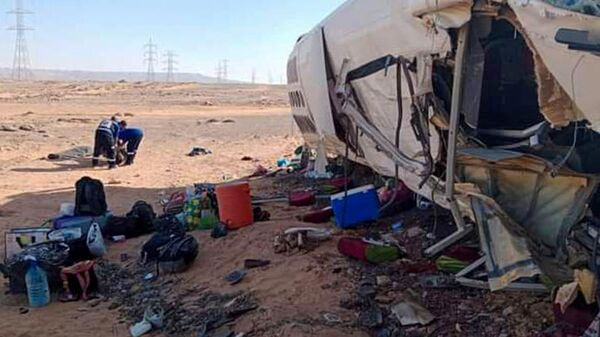 A picture shows the remains of a bus at the site of the crash on a road between the Egyptian town of Aswan and the famed Abu Simbel temple in southern Egypt on July 7, 2022. - A bus collided with a truck in southern Egypt killing nine Sudanese and injuring dozens of other people Thursday, official media reported. The bus carrying the Sudanese and truck loaded with ice crashed on the desert route between Abu Simbel and Aswan, near the Sudanese border, state-run newspaper Akhbar Al-Youm reported. - Sputnik International