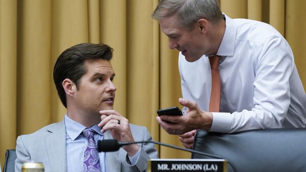 Rep. Matt Gaetz, R-Fla.,left, and Rep. Jim Jordan, R-Ohio, confer as the House Judiciary Committee holds an emergency meeting to advance a series of Democratic gun control measures, called the Protecting Our Kids Act, in response to mass shootings in Texas and New York, at the Capitol in Washington, Thursday, June 2, 2022. - Sputnik International