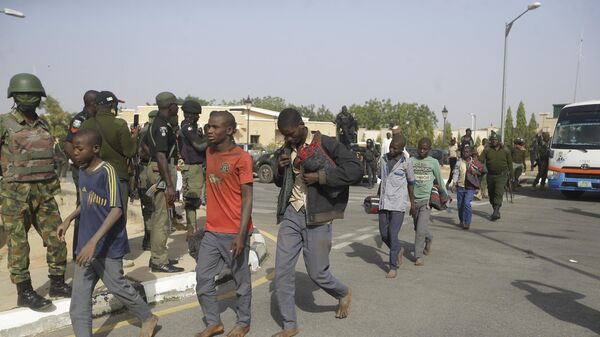 A group of schoolboys are escorted by Nigerian military and officials following their release after they were kidnapped last week, Friday Dec. 18, 2020 in Katsina, Nigeria. - Sputnik International