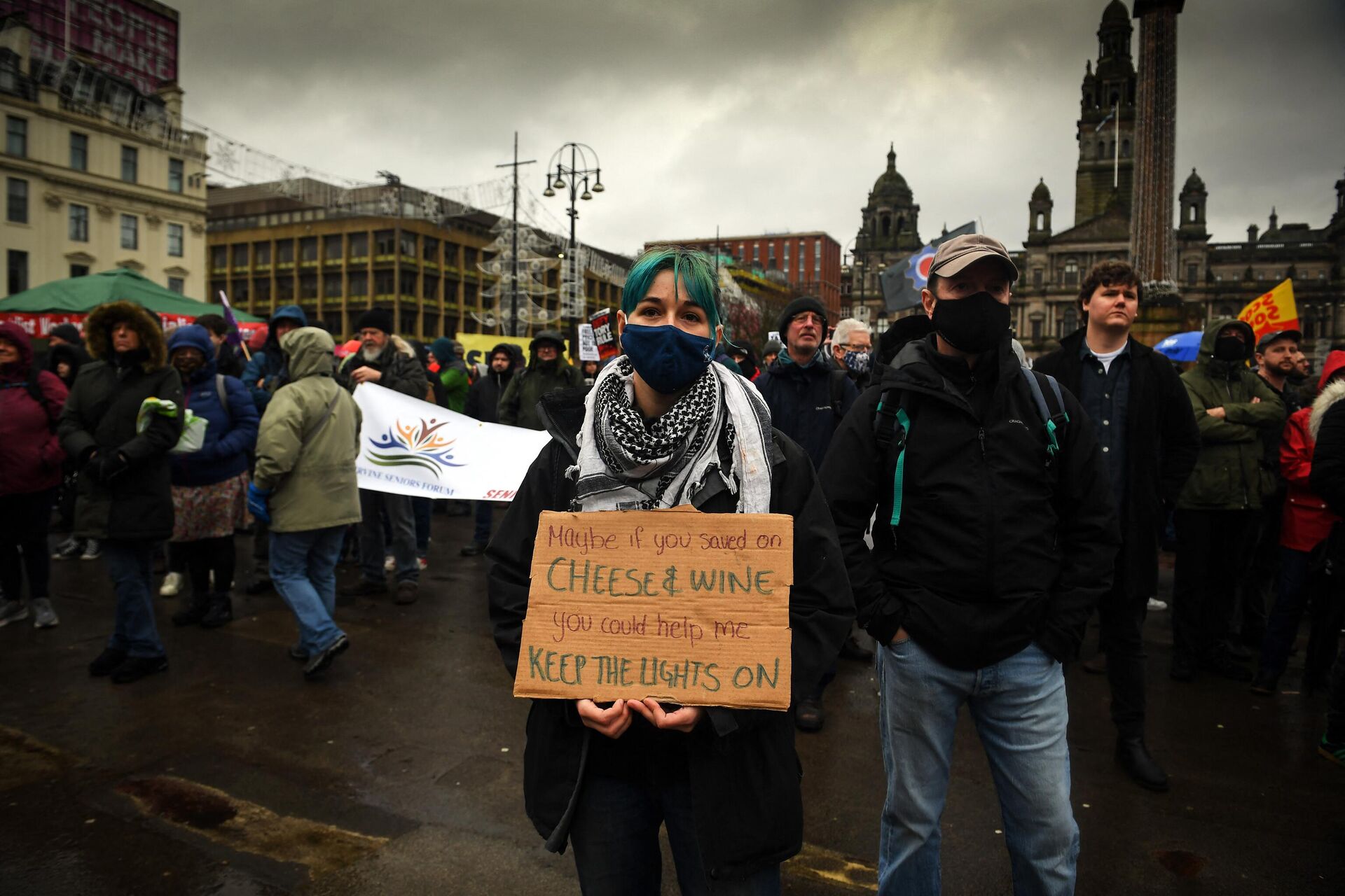 Demonstrators hold up placards as they take part in a march organised by The People's Assembly to demand action to tackle the cost of living crisis in Glasgow, Scotland on February 12, 2022. - Sputnik International, 1920, 29.12.2022