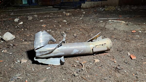 A fragment of a shell lies on the ground in Donetsk after a recent shelling from Ukrainian troops - Sputnik International