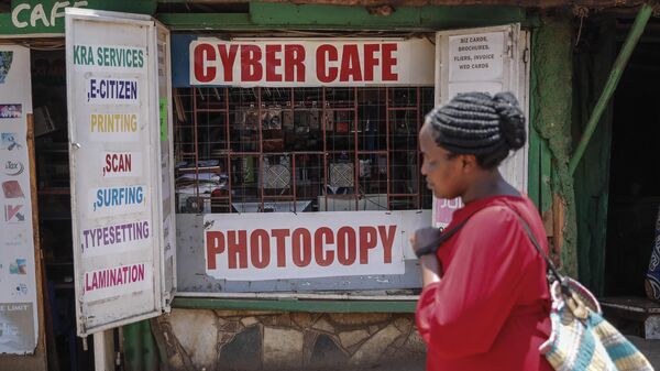 A pedestrian walks past an internet cafe in the low-income Kibera neighborhood of Nairobi, Kenya, on Wednesday, Sept. 29, 2021. Instead of serving Africa's internet development, millions of internet addresses reserved for Africa have been waylaid, some fraudulently, including in insider machinations linked to a former top employee of the nonprofit that assigns the continent's addresses.  - Sputnik International