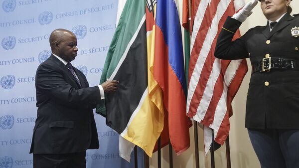 Mozambique's United Nations Ambassador Pedro Comissário Afonso, left, installs his country's flag during ceremony for five newly-elected non-permanent members to serve on the United Nations Security Council for the term 2023-2024, Tuesday Jan. 3, 2023 at U.N. headquarters. - Sputnik International