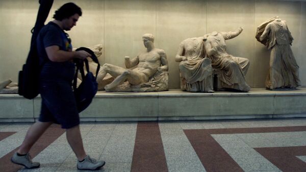 A passenger walks past copies of some of the Parthenon Sculptures displayed in the British Museum, at the Acropolis Metro station in Athens, on Thursday, June 11, 2009.  - Sputnik International
