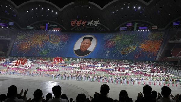 In this July 16, 2019, photo, North Koreans hold cards to make an image depicting of their leader Kim Jong Un during a mass game performance of The Land of the People at the May Day Stadium in Pyongyang, North Korea.  - Sputnik International