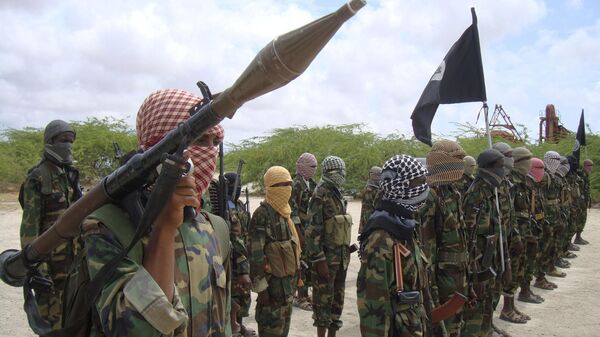 In this file photo of Thursday Oct.21, 2010, Al-Shabaab fighters display weapons as they conduct military exercises in northern Mogadishu, Somalia. The new al-Shabab video, called “The Path to Paradise,” promises more in a series spotlighting recruits from Minnesota who abandoned the comforts of home in order to wage jihad against foreign troops in Somalia. The video, which was originally available on YouTube but has since been taken down because it violates the website’s policy on violence, features masked men performing military drills in dusty camps as well as what appears to be footage of staged battles among Mogadishu’s ruined buildings. - Sputnik International