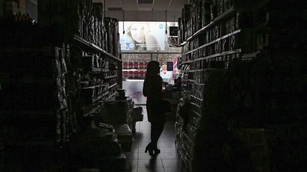 A customer in a	de-energized sale room of a store - Sputnik International