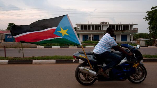 A man rides a motorbike with a South Sudanese flag during celebrations in the streets of Juba ahead of South Sudan's independence first anniversary, on July 8, 2012. - Sputnik International