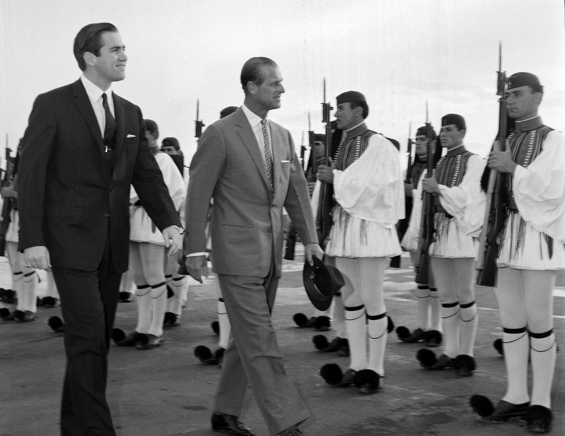 FILE - In this March 25, 1965 file photo, King Constantine II of Greece, left, and Prince Philip of Britain review an honor guard of the Greek Royal Evzones Guard as the prince arrives at the Athens Airport for a brief visit as the guest of the Greek royal family. Prince Philip's life spanned just under an entire century of European history. His genealogy was just as broad, with Britain's longest-serving consort linked by blood and marriage to most of the continent's royal houses. - Sputnik International, 1920, 10.01.2023