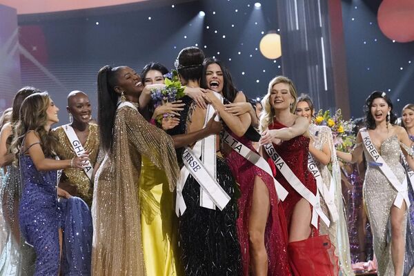 Gabriel was crowned by the 70th Miss Universe, Harnaaz Sandhu.Above: Miss USA R&#x27;Bonney Gabriel, back to camera, is hugged by other contestants after being crowned Miss Universe. - Sputnik International