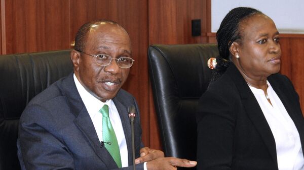 Central Bank of Nigeria's (CBN) governor Godwin Emefiele (L) and deputy governor Sarah Alade give a press conference on the naira devaluation during a media briefing in Abuja on June 15, 2016. - Sputnik International