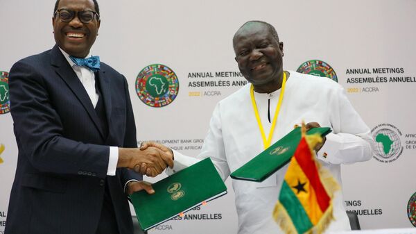 Kenneth Ofori-Atta (R), Ghana’s Minister of Finance, exchange signed documents for the Ghana Solar Photovoltaic-Based Net Metering Project in Accra, Ghana, on May 25, 2022 with Dr Akinwuni A. Adesina (L), president of the African Development Bank Group. - Sputnik International