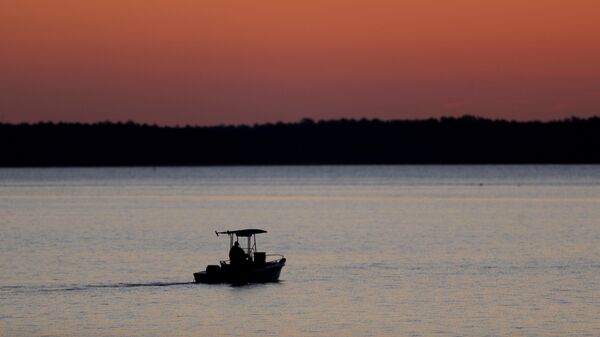 FILE - A small boat travels along the Honga River near the Chesapeake Bay, as the sky lights up at sunrise in Fishing Creek, Md., May 14, 2020. In an evaluation released on Thursday, Jan. 5, 2023, the Chesapeake Bay Foundation, an environmental group, gave the Chesapeake Bay watershed a D-plus grade, the same grade it gave the watershed in its last report in 2020.  - Sputnik International